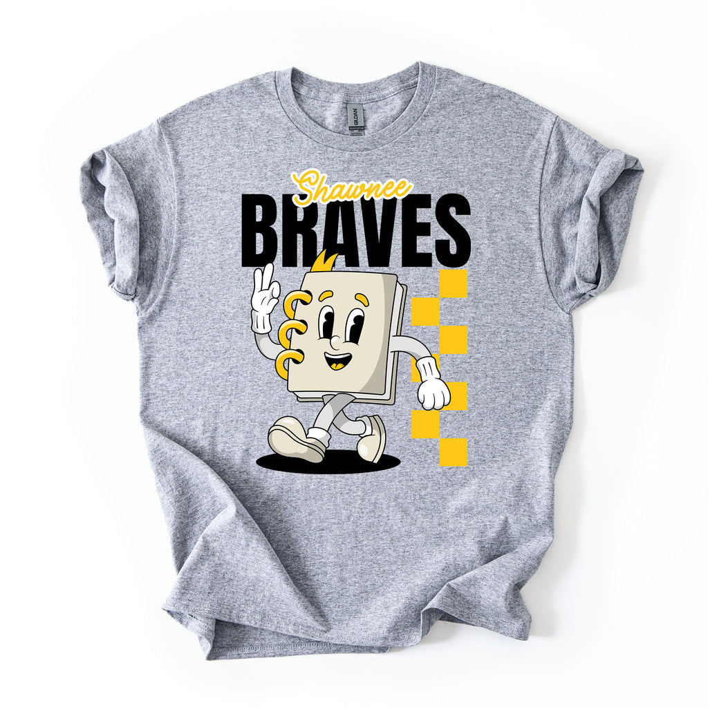A heather gray short-sleeve t-shirt with a graphic print of a cartoon character notebook with yellow accents, the text 'Shawnee BRAVES' in black and yellow, and a yellow checkered pattern, shown on a plain white background.