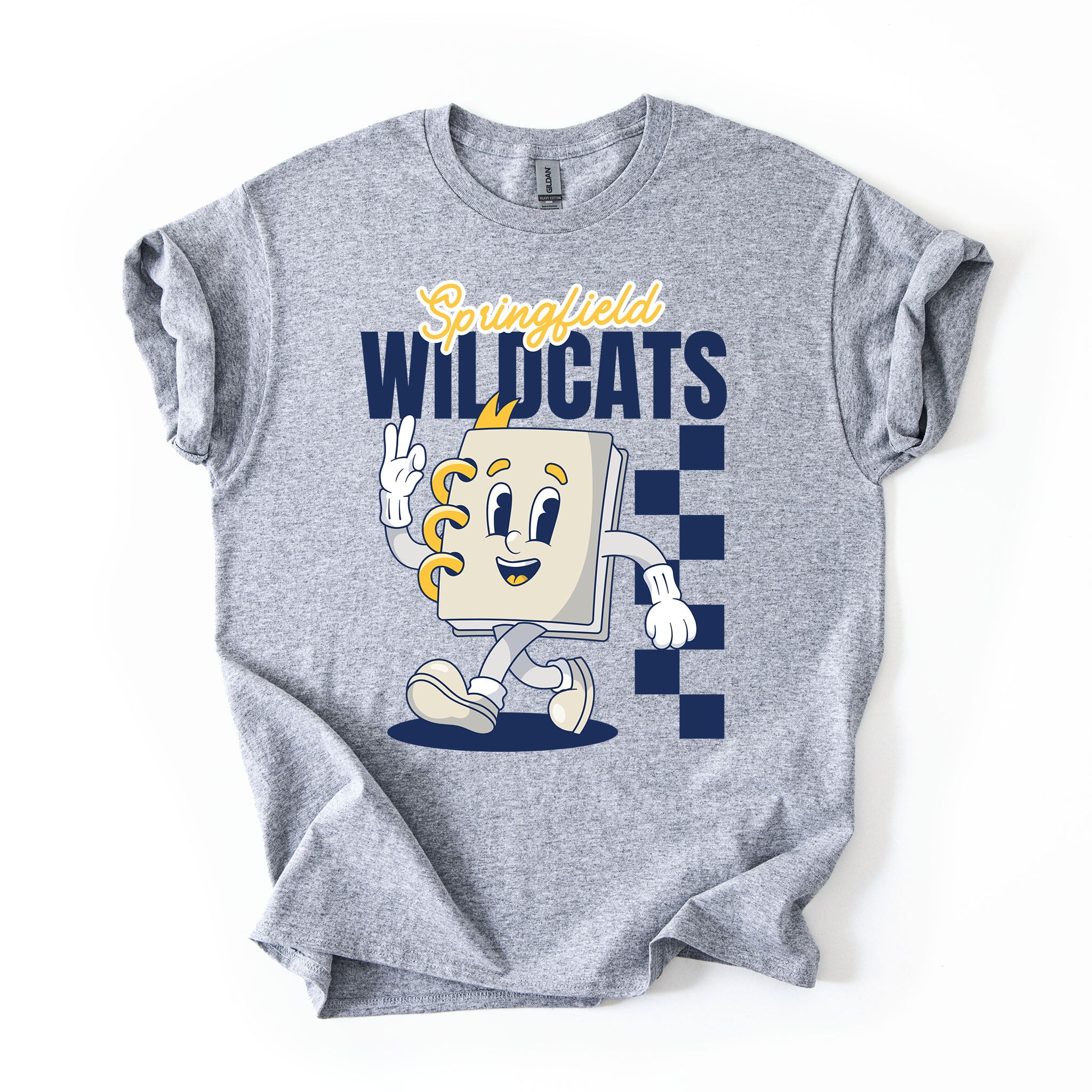 A heather gray short-sleeve t-shirt with a 'Springfield Wildcats' graphic on the front, featuring a cartoon notebook character and navy blue checkerboard details, laid flat on a white background.